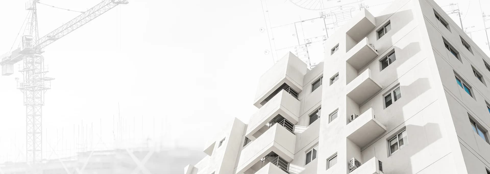 Modern white building with architectural plans in the background